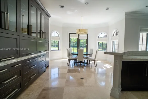a large kitchen with stainless steel appliances granite countertop a stove and a view of living room
