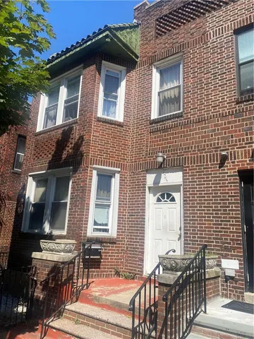 a front view of a house with outdoor seating