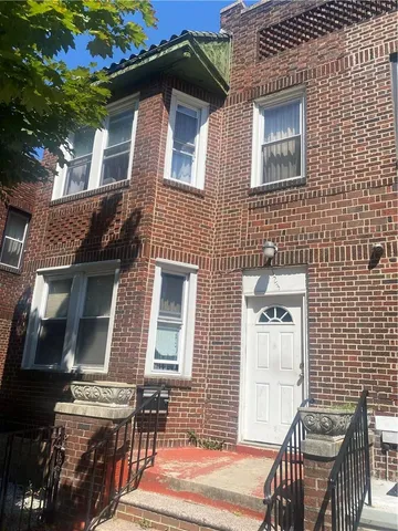 a front view of a house with outdoor seating