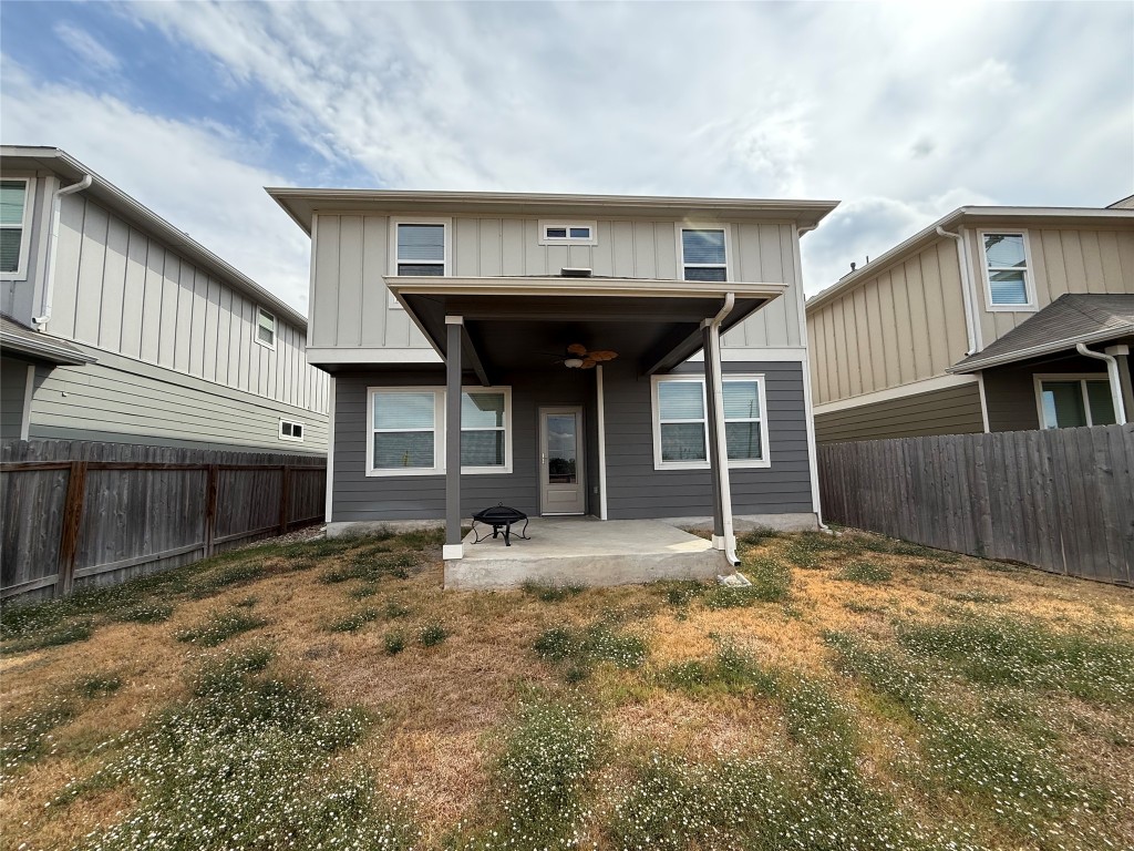 12110 Corsicana Trail, Unit 19B Manor, TX 78653 - Photo 20 of 23 Rear view of property featuring ceiling fan, a patio area, a fenced backyard, and board and batten siding