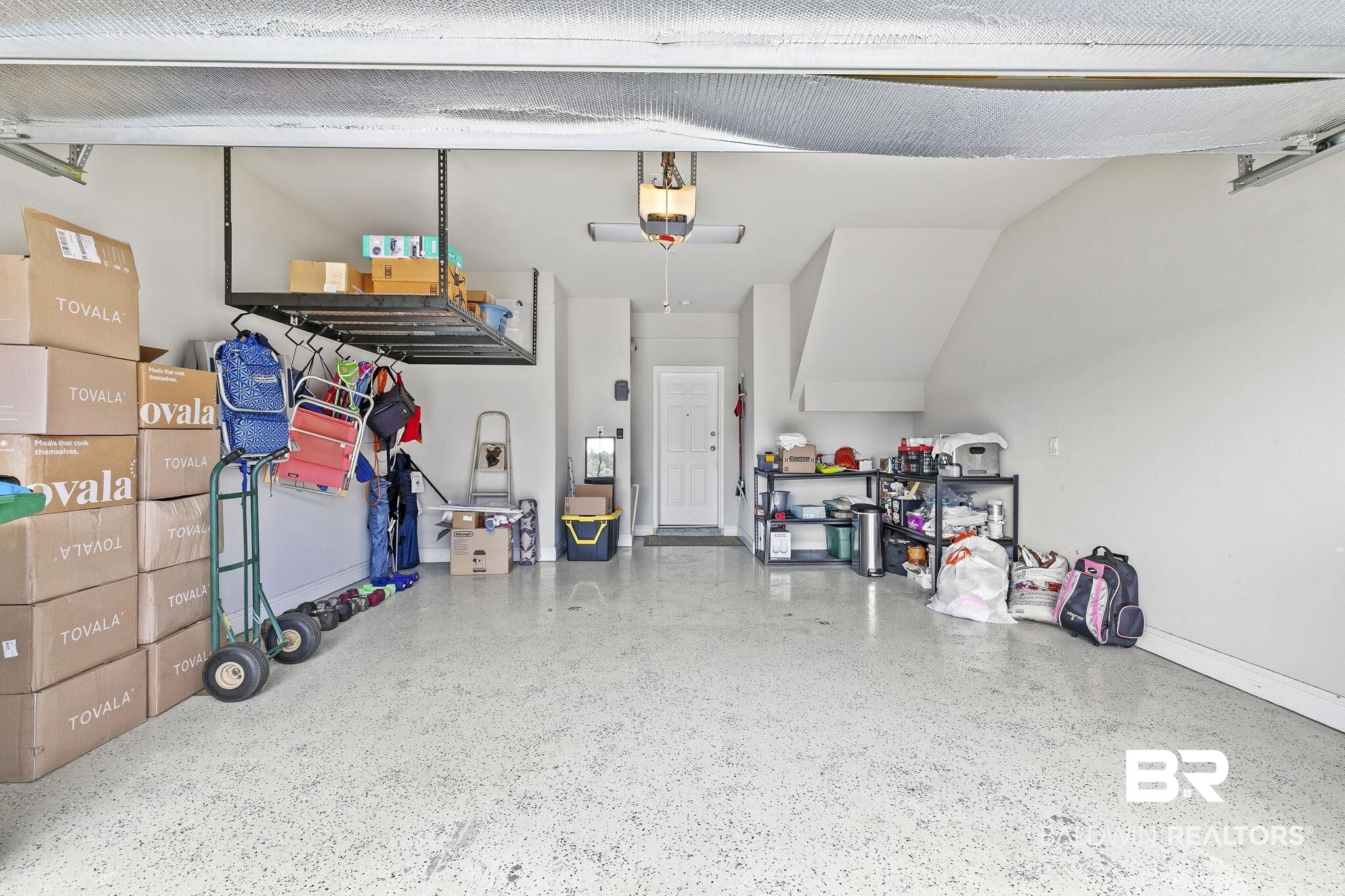 6867 Spaniel Drive, Unit B Daphne, AL 36527 - Photo 23 of 36 Garage with a garage door opener