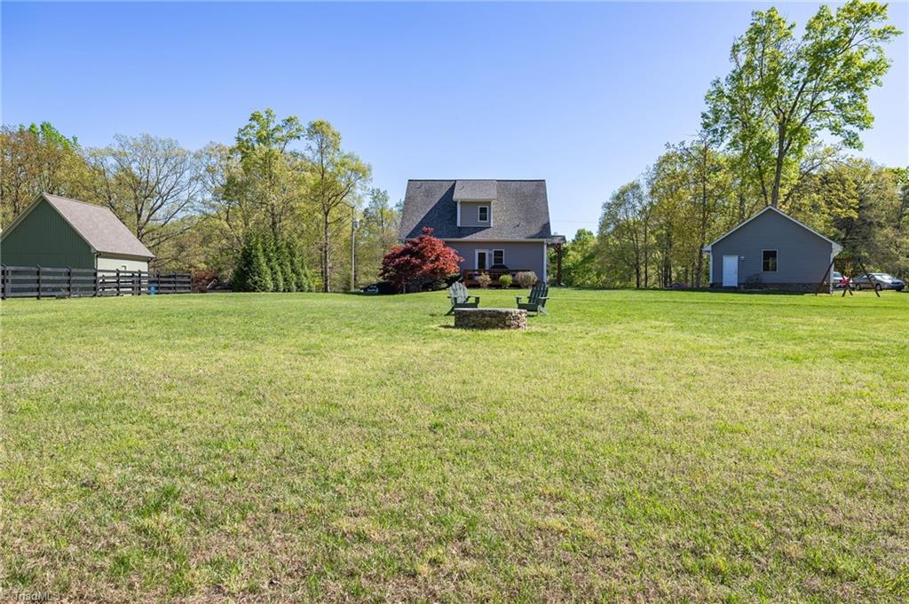 129 Kidd Road Colfax, NC 27235 - Photo 43 of 45 Back Yard View w/Fire Pit