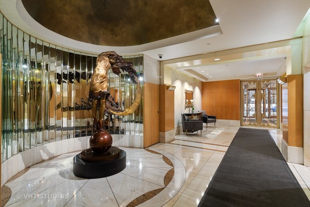 111 East Chestnut Street, Unit 43A Chicago, IL 60611 - Photo 14 of 16 a living room with furniture and a potted plant