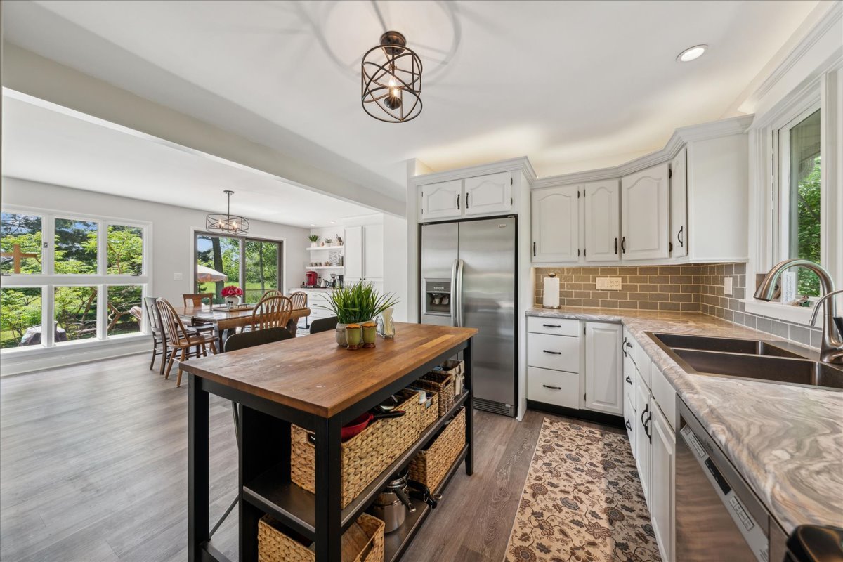 2N989 Beith Road Elburn, IL 60119 - Photo 12 of 35 a kitchen with stainless steel appliances granite countertop a stove refrigerator sink and dishwasher with wooden floor
