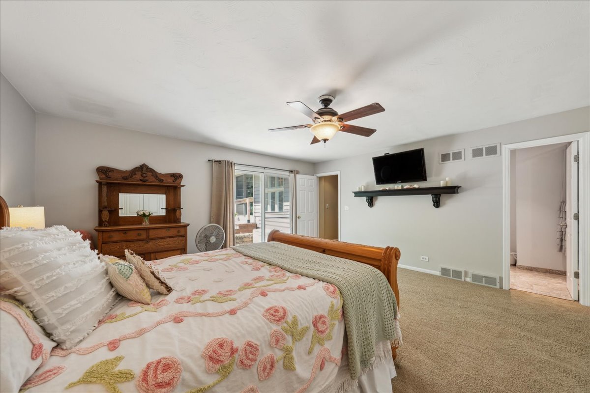 2N989 Beith Road Elburn, IL 60119 - Photo 17 of 35 a bedroom with a bed and a flat screen tv