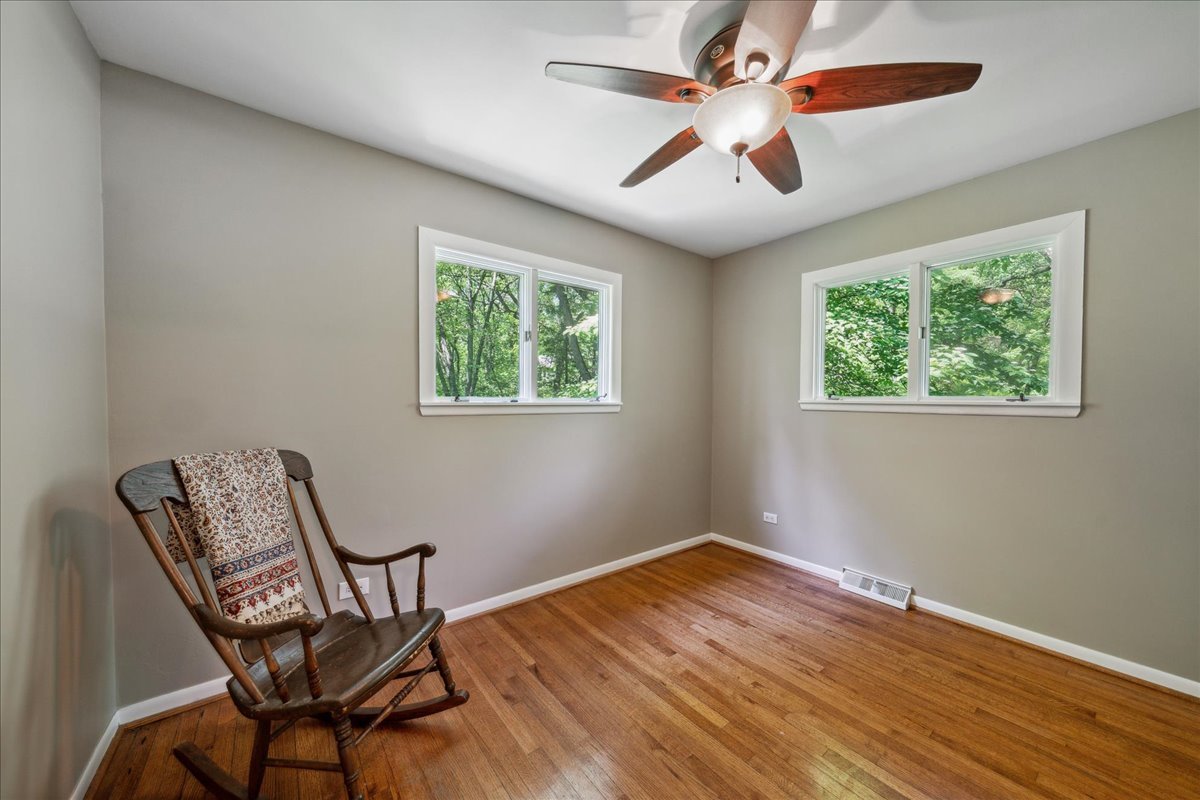 2N989 Beith Road Elburn, IL 60119 - Photo 22 of 35 a view of a room with wooden floor chandelier fan and windows
