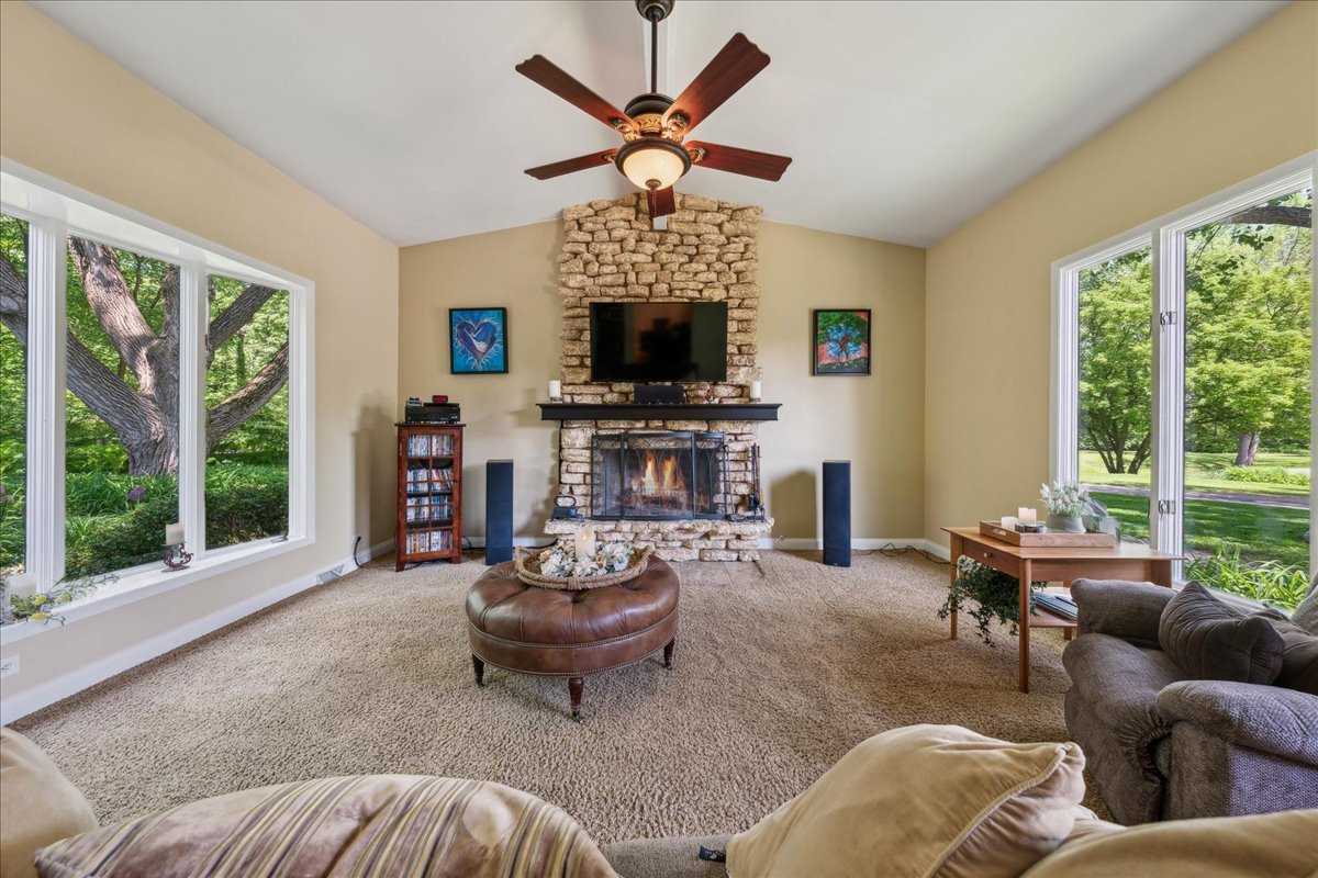 2N989 Beith Road Elburn, IL 60119 - Photo 6 of 35 a living room with furniture a fireplace and a floor to ceiling window