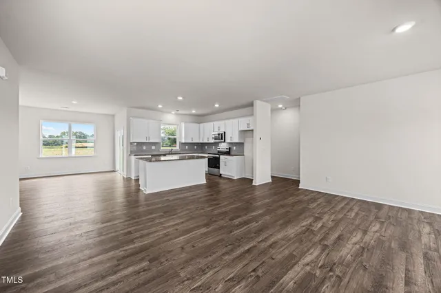a view of kitchen with kitchen island wooden floor and center island