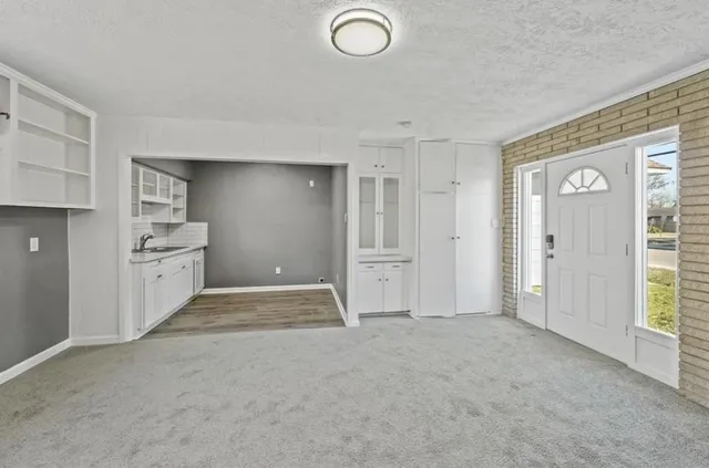 an empty room with windows and closet