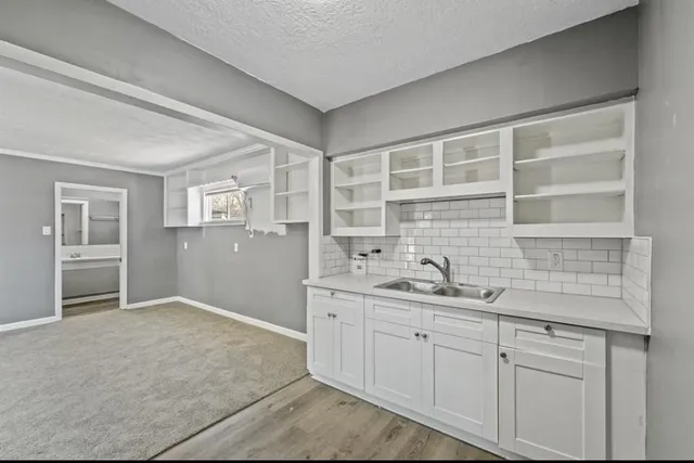 a kitchen with a sink and cabinets