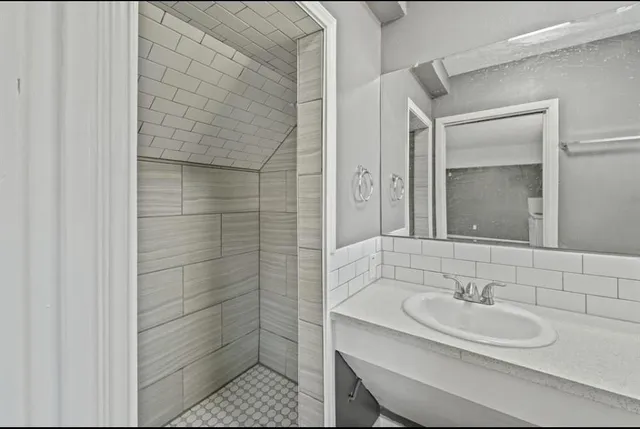 a bathroom with a sink and a mirror