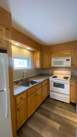 a kitchen with granite countertop cabinets stainless steel appliances and a sink