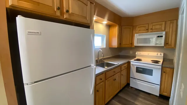 a kitchen with a stove microwave and sink