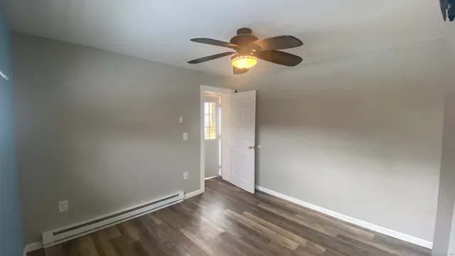 a view of a small space with wooden floor and windows