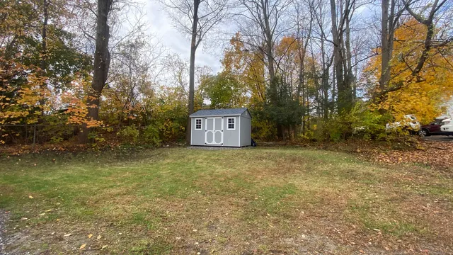 a house is sitting in middle of forest