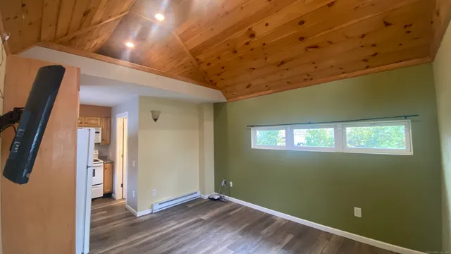 a view of a livingroom with wooden floor and windows