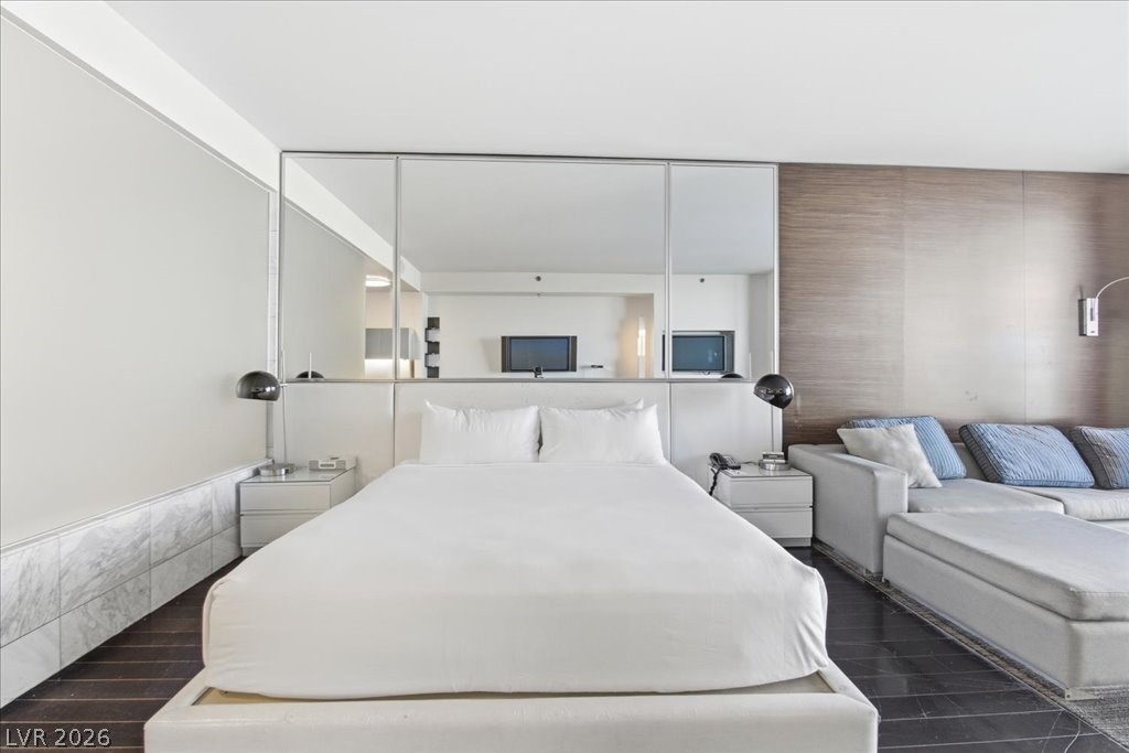 4381 West Flamingo Road, Unit 10306 Las Vegas, NV 89103 - Photo 8 of 26 This spacious bedroom offers a tranquil retreat with sleek design and comfortable living.