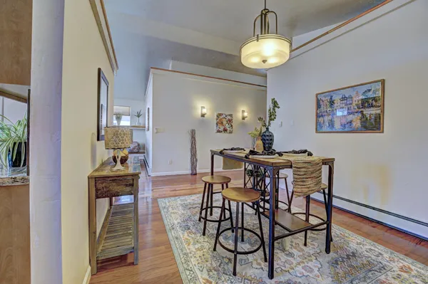 a dining room with furniture and wooden floor