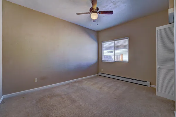 an empty room with closet area