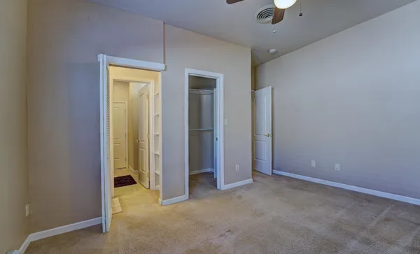 a en suite bathroom with a granite countertop sink and a mirror