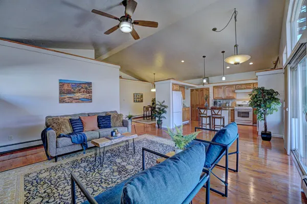 a living room with furniture and wooden floor