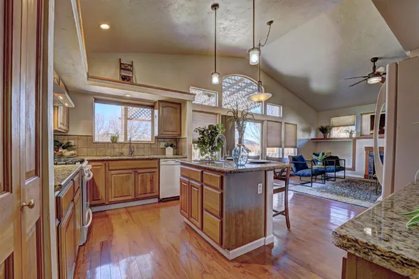 a kitchen with stainless steel appliances granite countertop a stove and cabinets