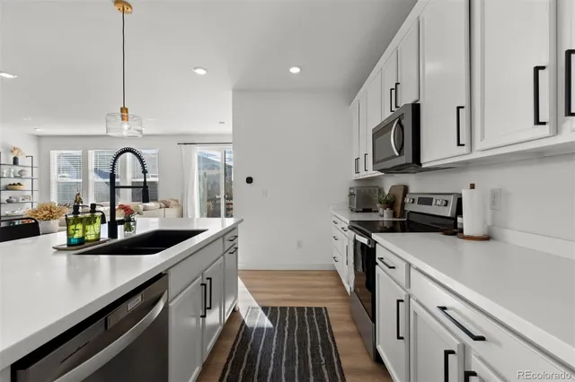 a kitchen with stainless steel appliances granite countertop a sink and cabinets