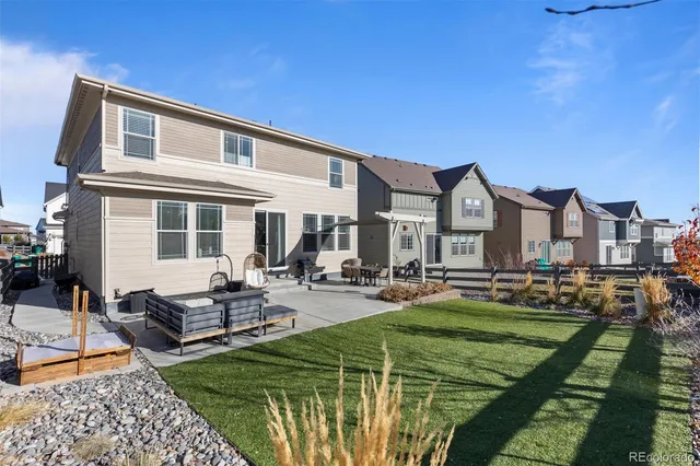 a view of a house with swimming pool and sitting area
