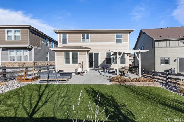 a view of a house with patio and a yard