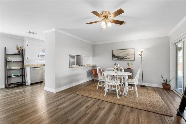 a view of a dining room with furniture and wooden floor