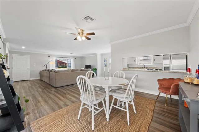 a view of a dining room with furniture and wooden floor
