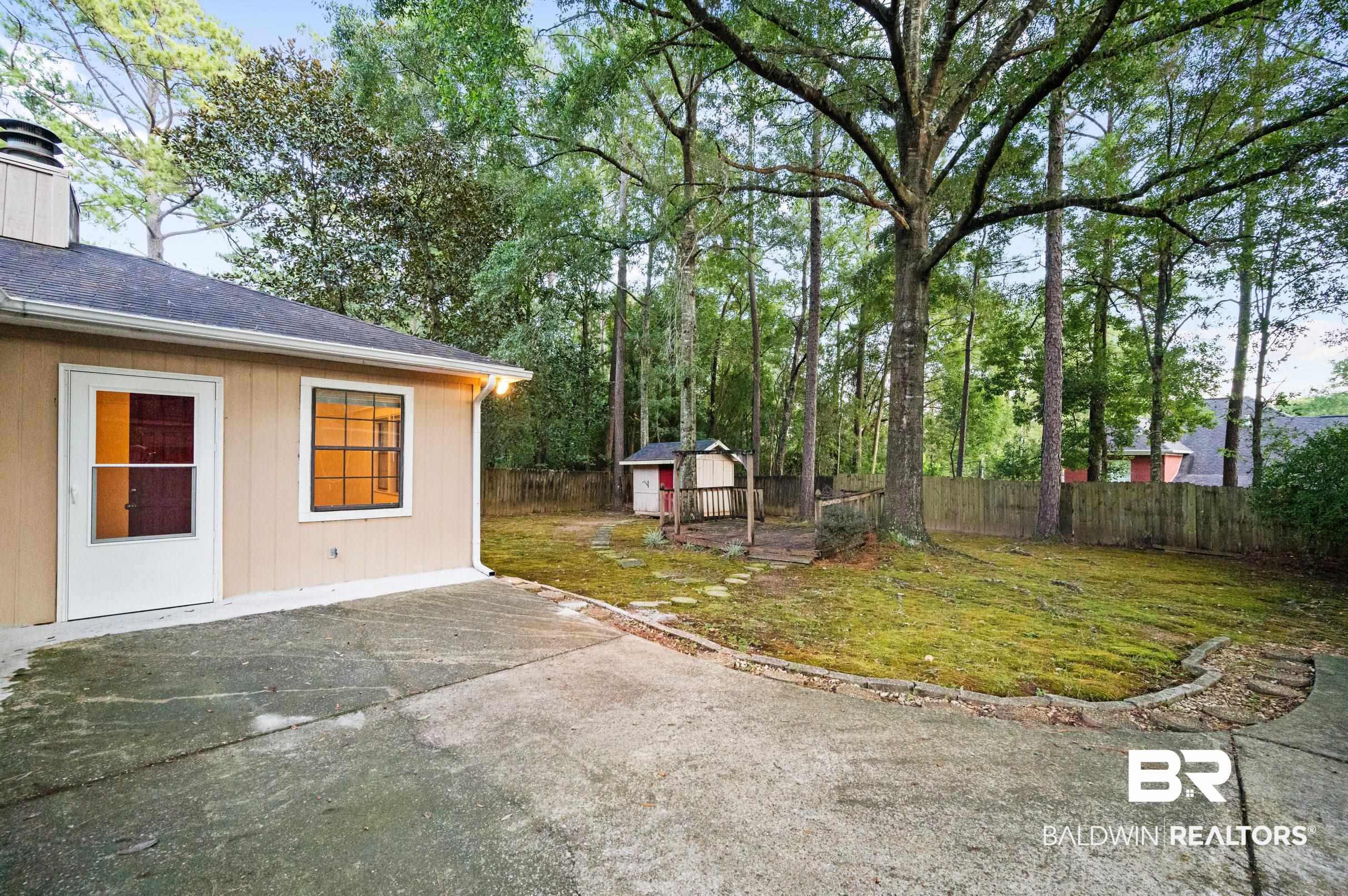 128 Dunbar Loop Daphne, AL 36526 - Photo 29 of 39 View of yard featuring a storage shed and a patio area