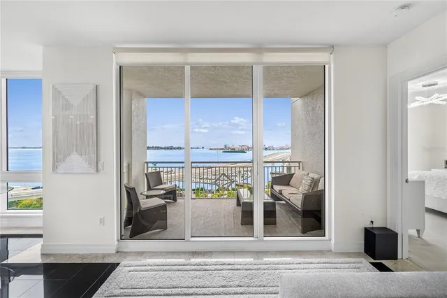 a living room with furniture a fireplace and a window