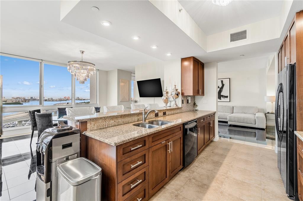 331 Cleveland Street, Unit 1103 Clearwater, FL 33755 - Photo 13 of 75 a spacious kitchen with stainless steel appliances granite countertop a sink and a stove