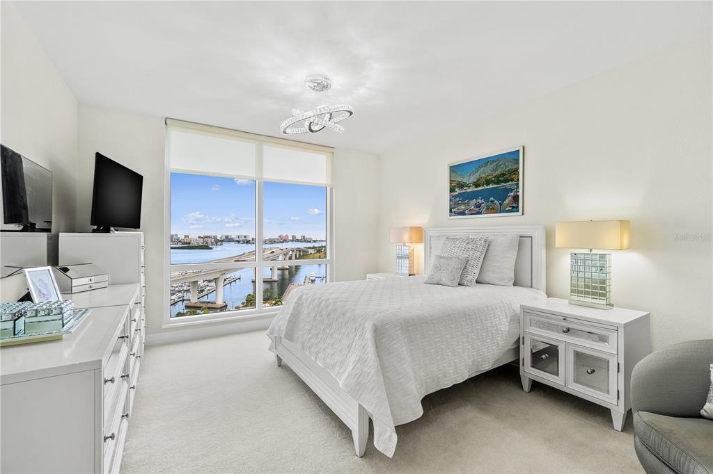 331 Cleveland Street, Unit 1103 Clearwater, FL 33755 - Photo 22 of 75 a bedroom with a bed and a flat tv screen on dresser