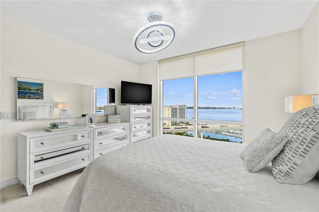 331 Cleveland Street, Unit 1103 Clearwater, FL 33755 - Photo 23 of 75 a bedroom with furniture and a flat screen tv