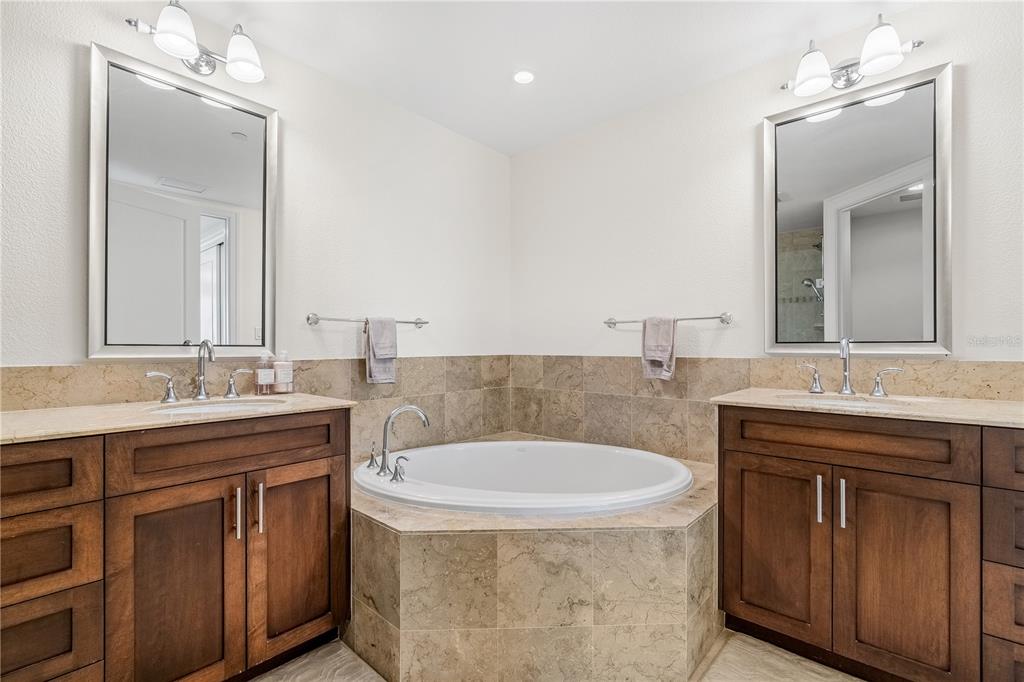 331 Cleveland Street, Unit 1103 Clearwater, FL 33755 - Photo 27 of 75 a bathroom with a granite countertop sink and a mirror