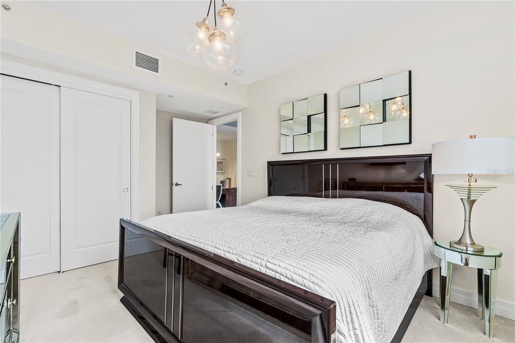 331 Cleveland Street, Unit 1103 Clearwater, FL 33755 - Photo 29 of 75 a bedroom with a bed and a chandelier