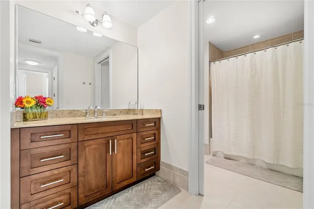 a kitchen with granite countertop a stove a sink and a refrigerator