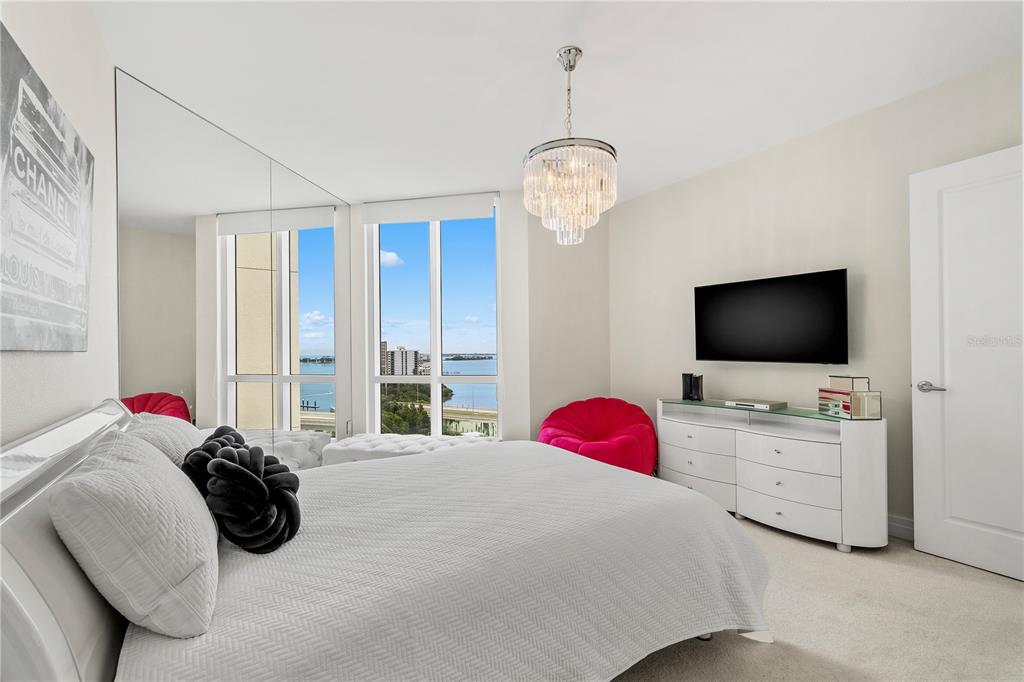 331 Cleveland Street, Unit 1103 Clearwater, FL 33755 - Photo 37 of 75 a bedroom with a bed and a flat screen tv