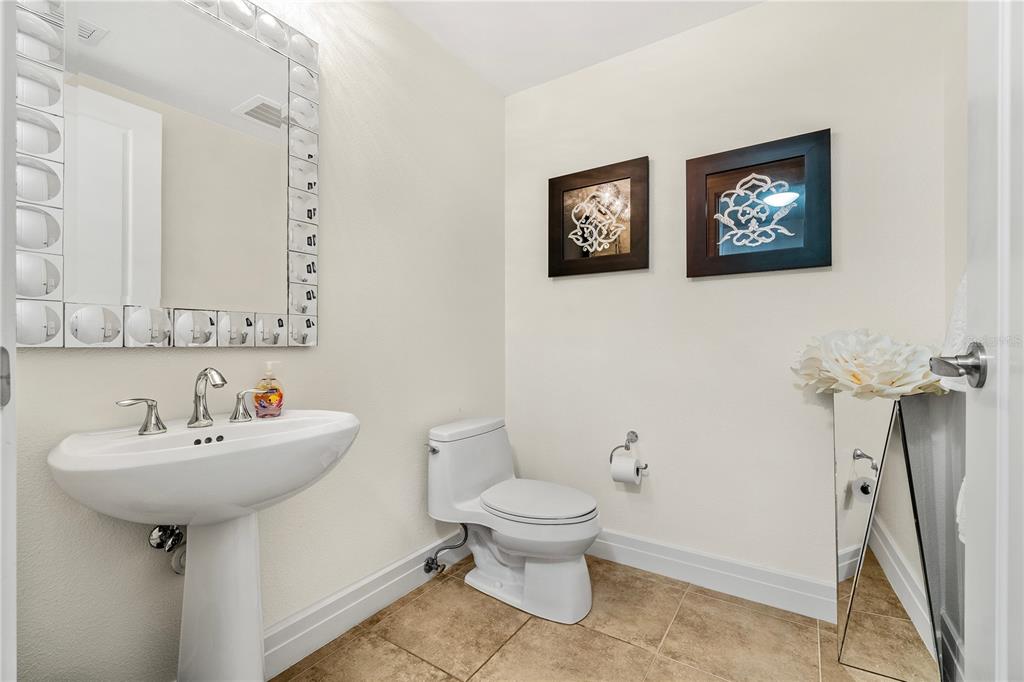 331 Cleveland Street, Unit 1103 Clearwater, FL 33755 - Photo 4 of 75 a bathroom with a sink toilet and a mirror