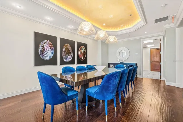 a view of a livingroom with workspace and a large window