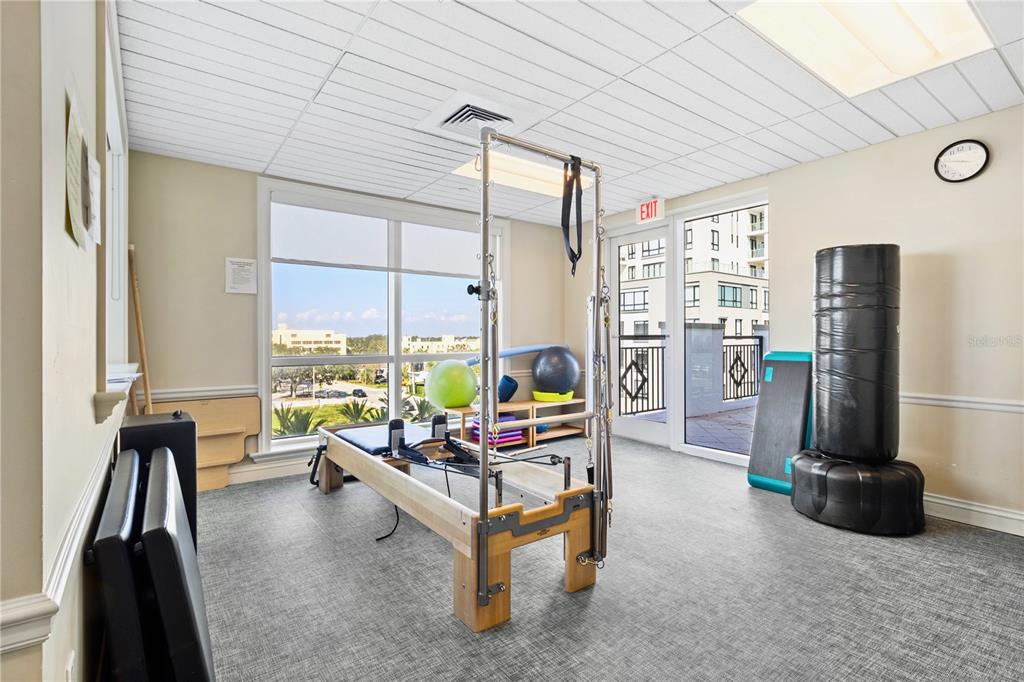 331 Cleveland Street, Unit 1103 Clearwater, FL 33755 - Photo 65 of 75 a living room with furniture gym equipment and a large window