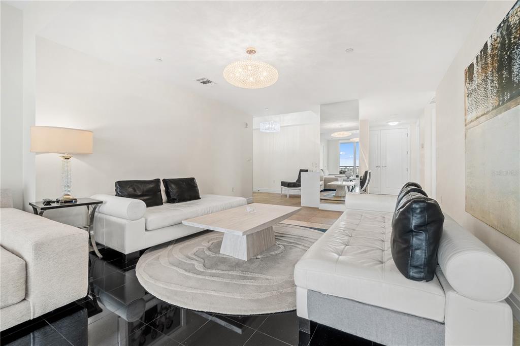 331 Cleveland Street, Unit 1103 Clearwater, FL 33755 - Photo 8 of 75 a living room with furniture a table and chairs