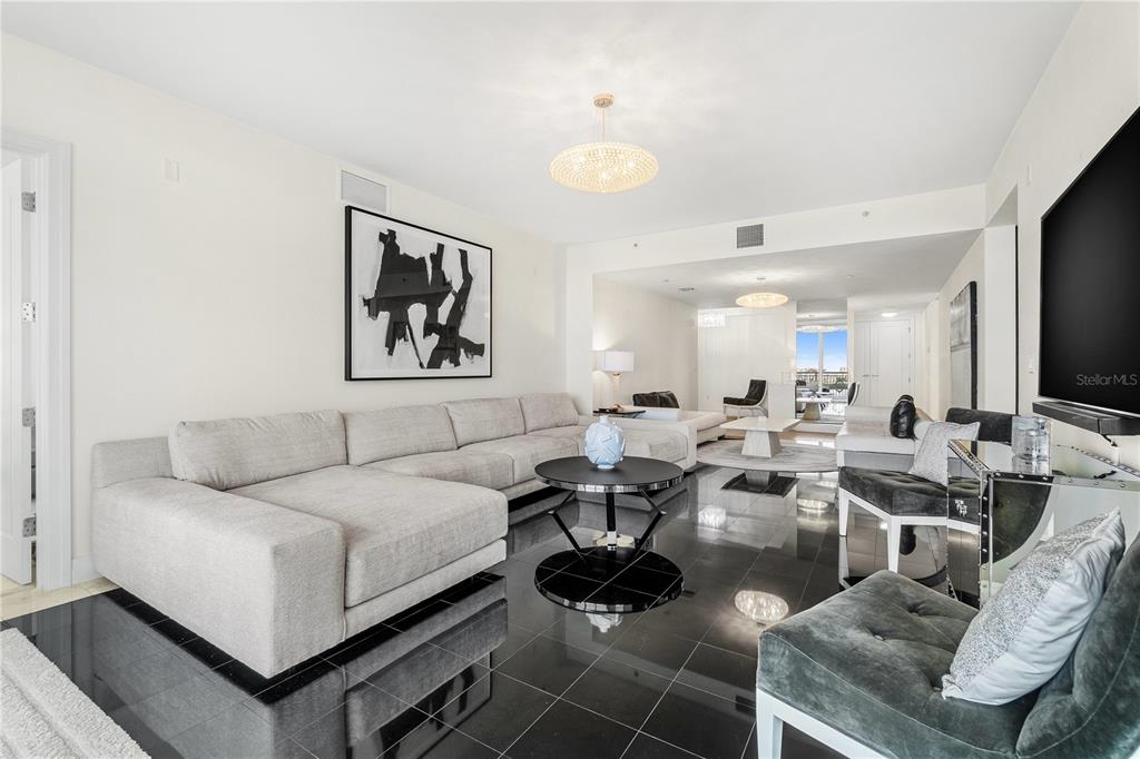 331 Cleveland Street, Unit 1103 Clearwater, FL 33755 - Photo 10 of 75 a living room with lots of furniture and a flat screen tv