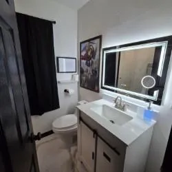 a bathroom with a sink toilet and shower