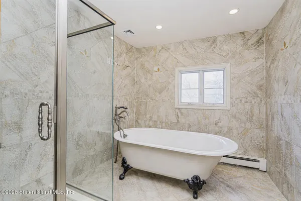 a bathroom with a granite countertop sink a mirror and shower