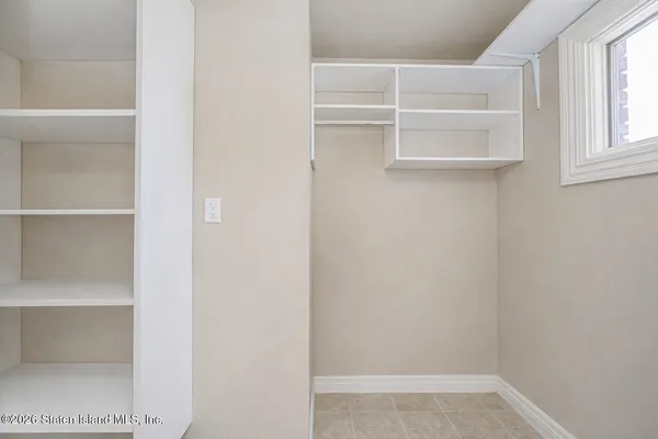 a view of a room with wooden floor and white walls