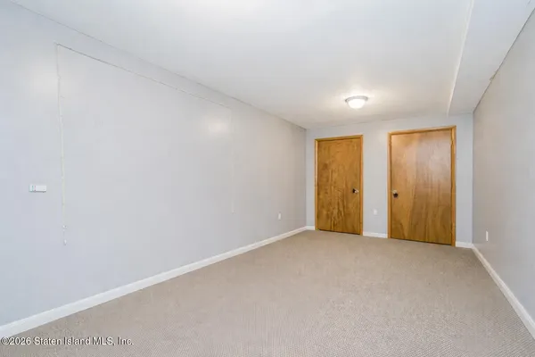 a view of a room with wooden floor and windows