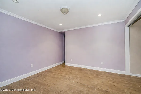 an empty room with a ceiling fan and a window